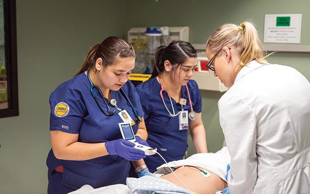 students perfrom gerontology simulation.